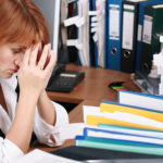 A woman has migraine in office